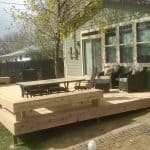 pic of a wood deck built in Loveland featuring built in seating and lighting