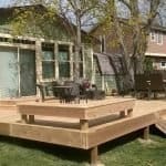 pic of a wood deck built in Loveland featuring built in seating and lighting